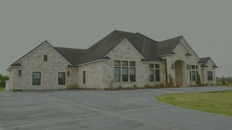 Stone exterior and driveway of Needville Cottage, a small assisted living home in Needville, Texas