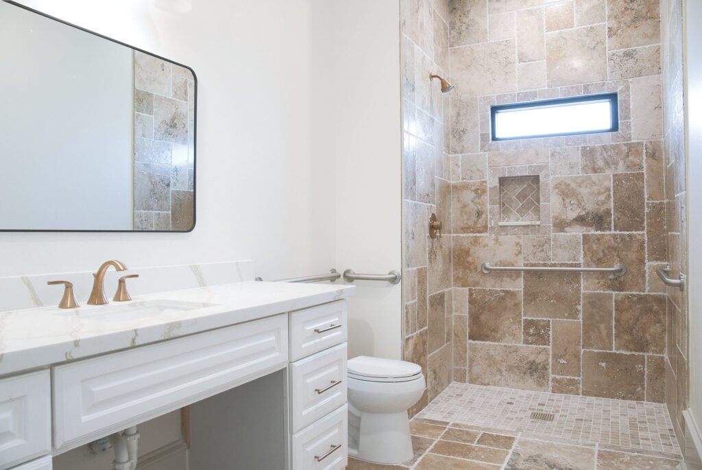 Accessible bathroom with a walk-in shower and grab bars at Village Forest Care Cottage in Needville