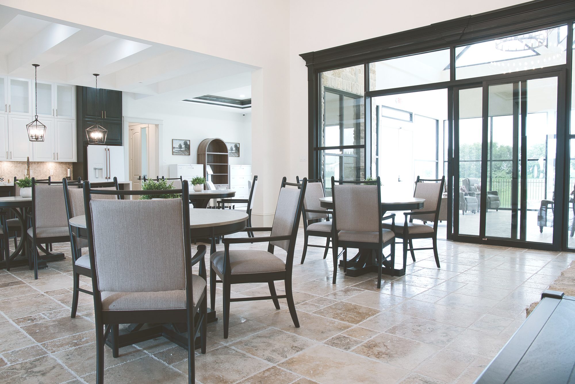 Dining room with a wall of windows at Needville Cottage assisted living in Needville, TX