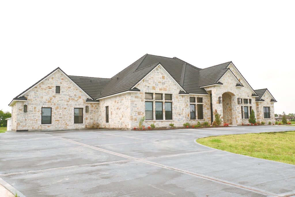 Driveway and stone exterior of Village Forest Care Cottage at 7306 Welch Ct in Needville, TX