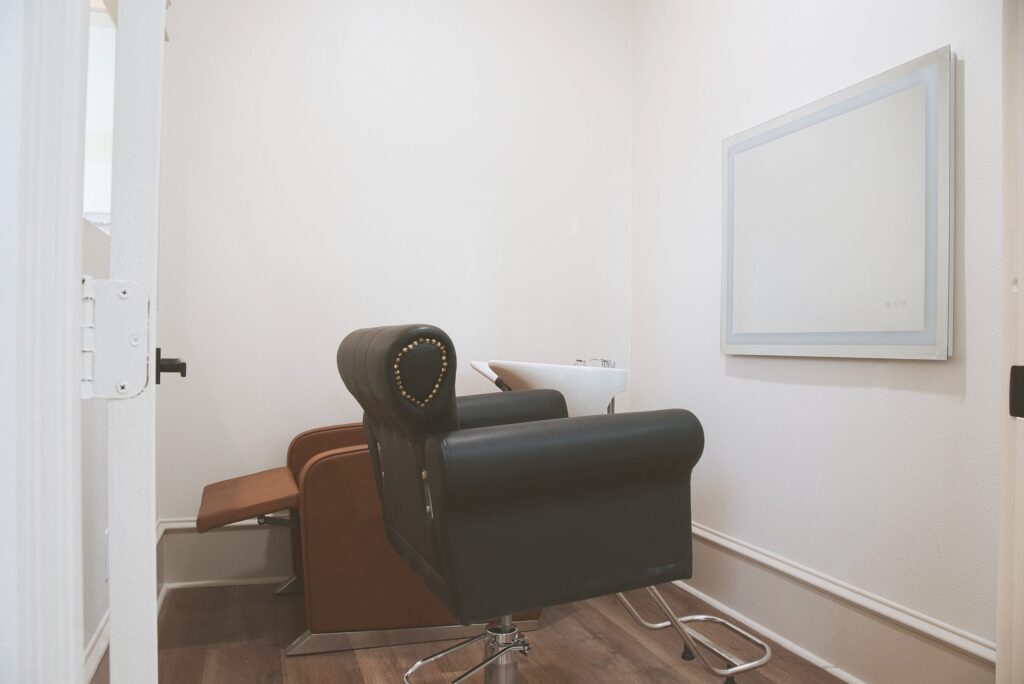 On-site salon with a styling chair and shampoo station at Village Forest Care Cottage in Needville